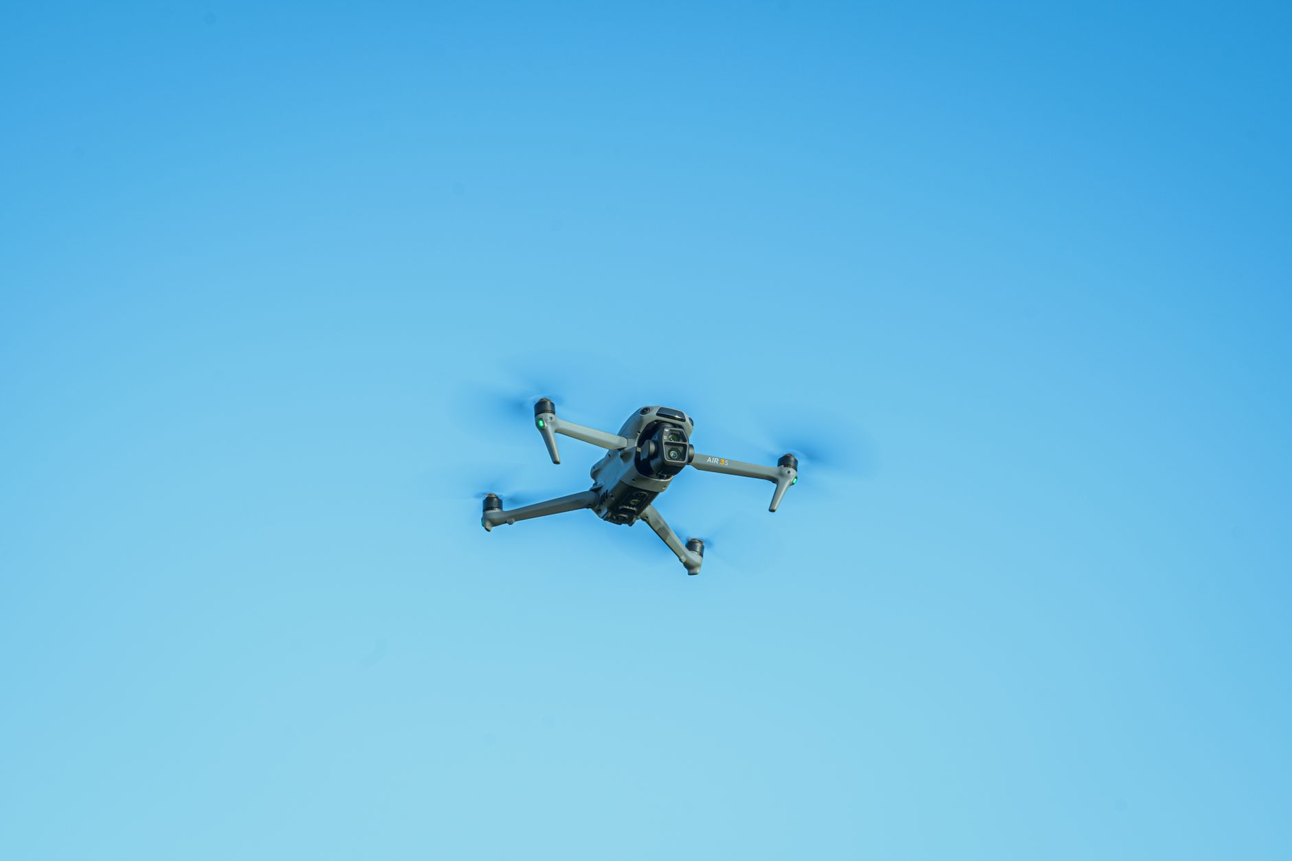 Drone conducting AI pothole detection survey over a cracked British road