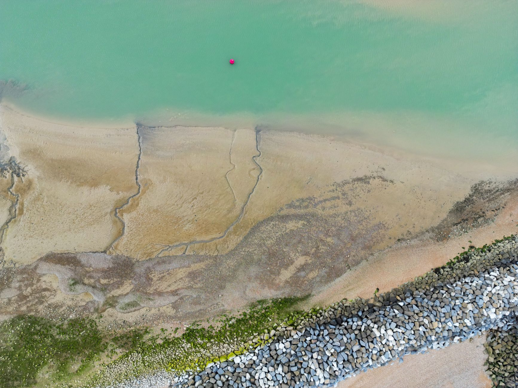 Drone operator surveying UK coastal erosion from a cliff top