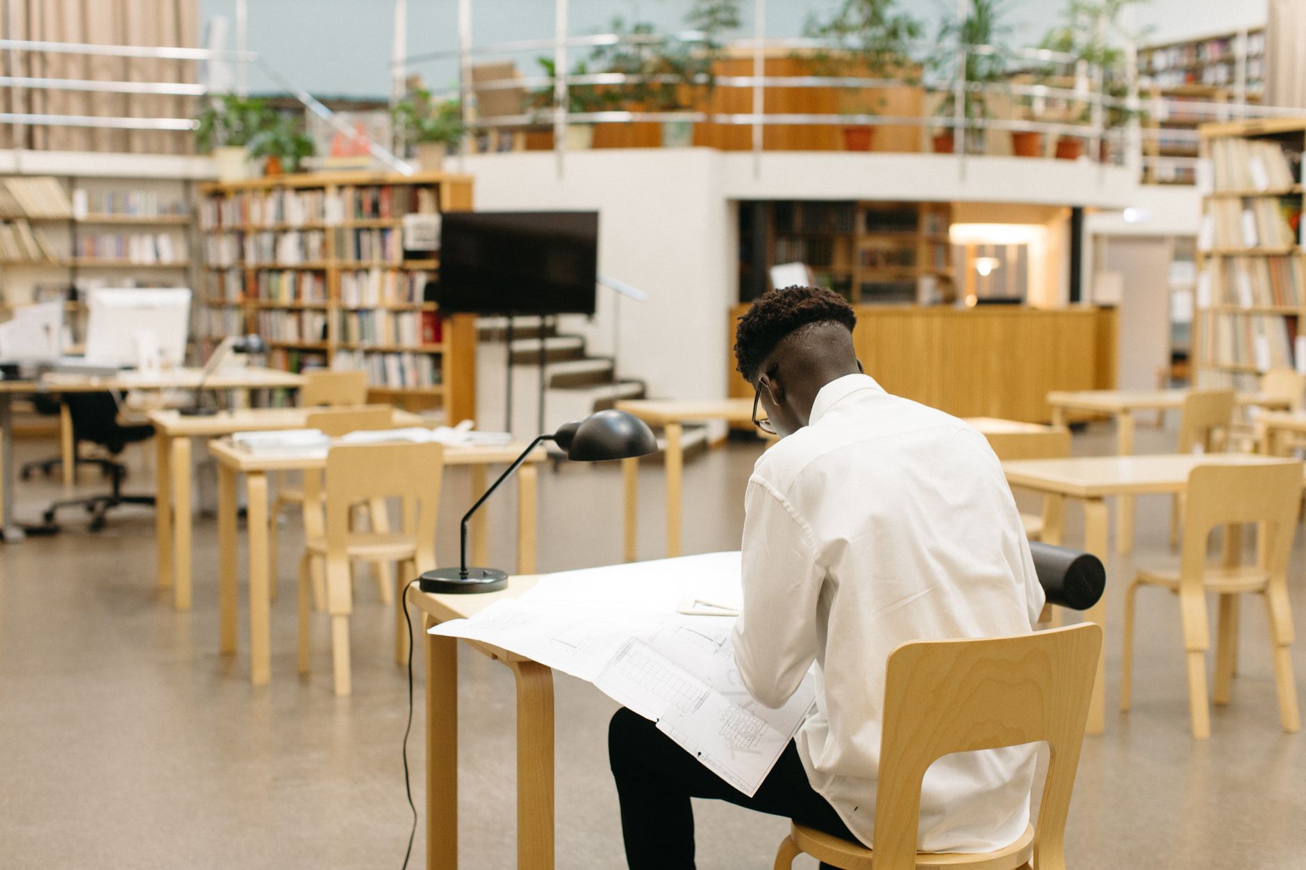 Remote worker using a public library reading room as a third space for working in the UK